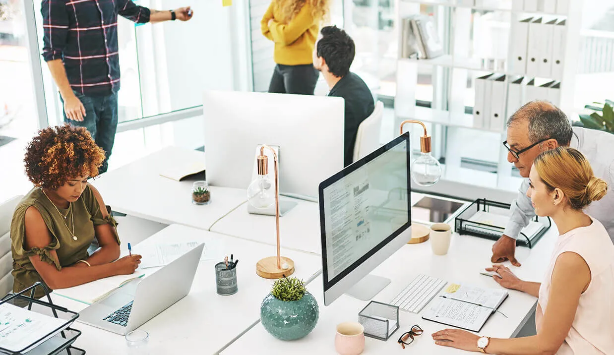 Various people working on iMac