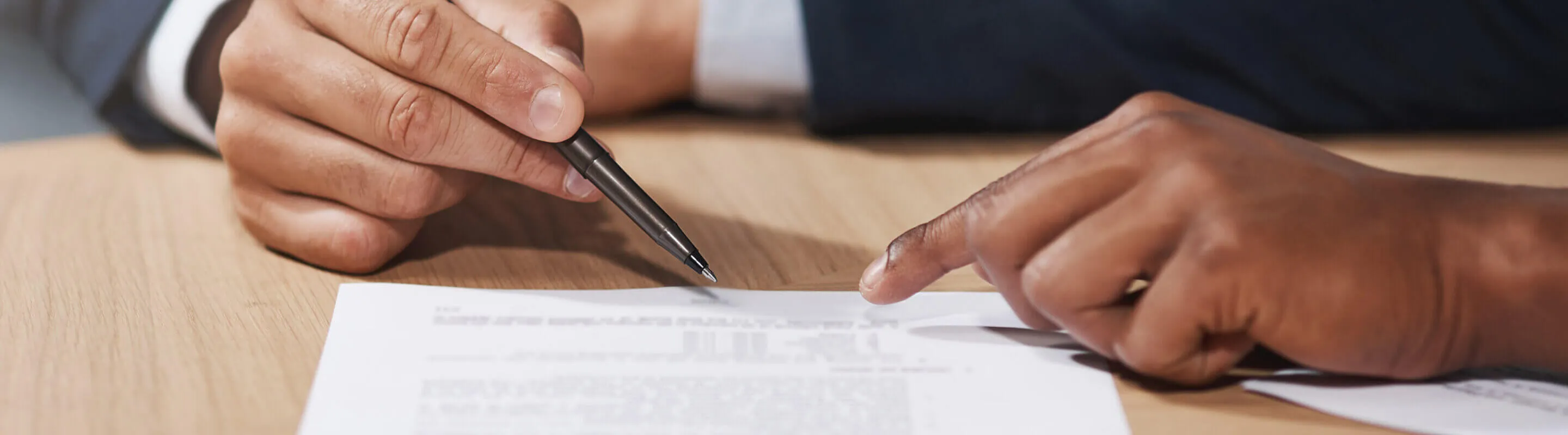 People chatting around a MacBook