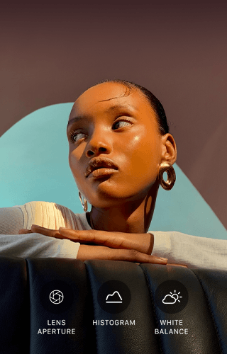 Close up portrait of a well-lit model with a colourful background, demonstrating the pro camera system's Pro controls UI: Lens Aperture, Histogram, White Balance