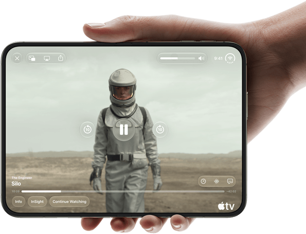 iPhone Duo, held with one hand, opened in horizontal orientation, fully unfolded, interior screen displays Apple TV show "Silo"