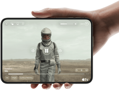 iPhone Duo, held with one hand, opened in horizontal orientation, fully unfolded, interior screen displays Apple TV show "Silo"