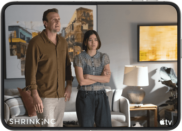iPhone Duo, opened in horizontal position, Apple TV show "Shrinking" plays on screen